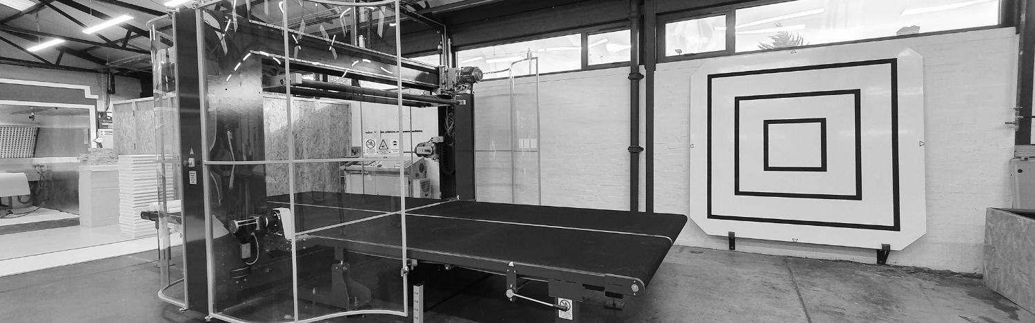 Aerofoam Ltd Panoramic view of the factory floor with organized foam sheets, machinery and safety signage.